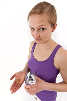 Young woman taking pills