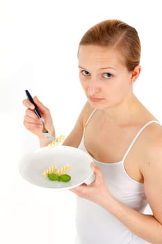 Young woman eating some noodles from almost empty plate