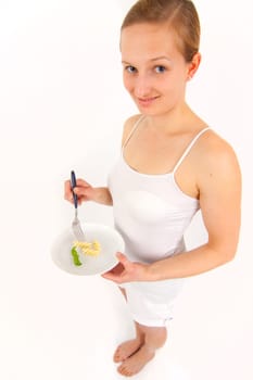 Young woman eating some noodles from almost empty plate