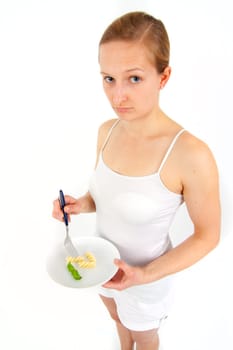 Young woman eating some noodles from almost empty plate