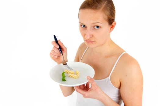 Young woman eating some noodles from almost empty plate