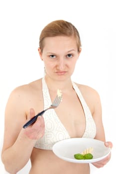 Young woman in bikini eating noodles from a small plate