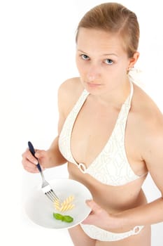 Young woman in bikini eating noodles from a small plate