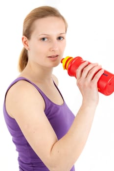 Young woman drinking from a drinking bottle