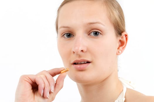 Young woman taking capsule