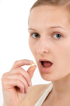 Young woman taking capsule