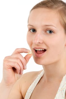 Young woman taking capsule
