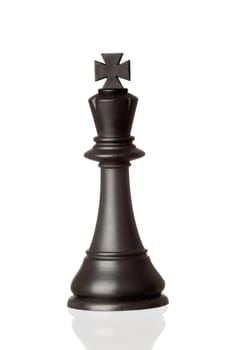 Black king chess piece isolated on white background with reflection on the floor