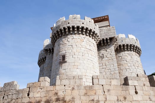 Great gray stone castle. A great strength under the blue sky