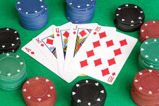 Poker cards with straight flush and many chips
