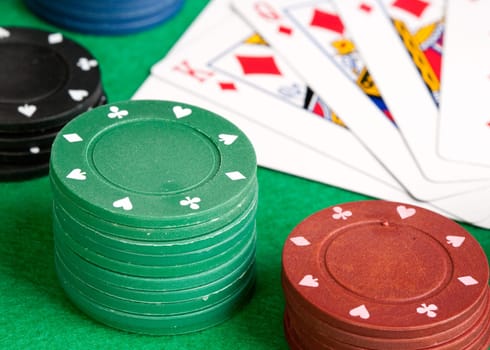 Poker cards and stacked chips of many colors