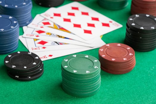 Poker cards with straight flush and many chips