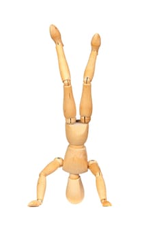 Jointed wooden mannequin doing handstands isolated on white background