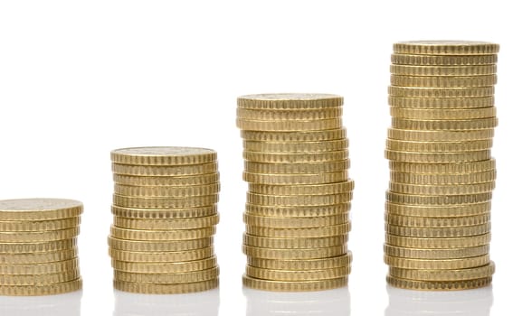 Four piles of money isolated on white