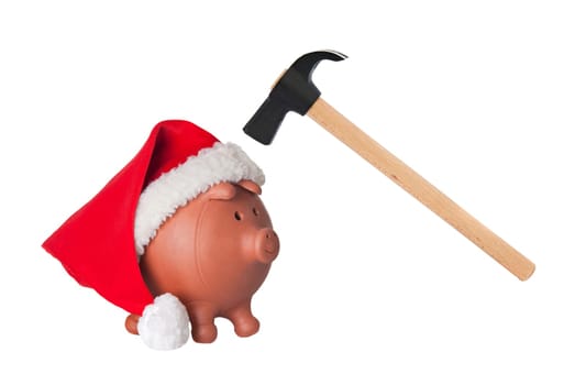 Piggy bank with Santa Claus hat and hammer isolated on white
