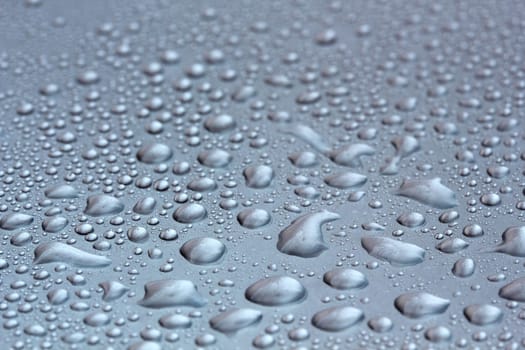 Water droplets on a shining mettallic surface