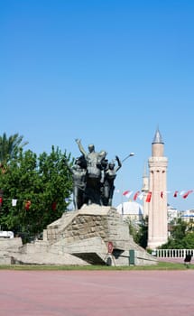 Monument of Mustafa Kemal Ataturk in Antalya, in background Yivli minaret