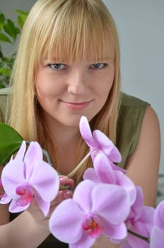 Young attractive woman with orchids