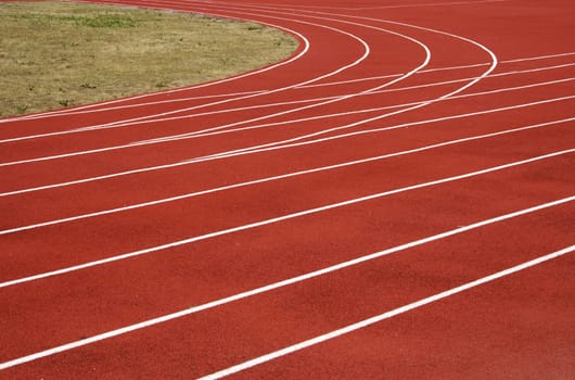Red asphalt for runners track turn zoomed foto