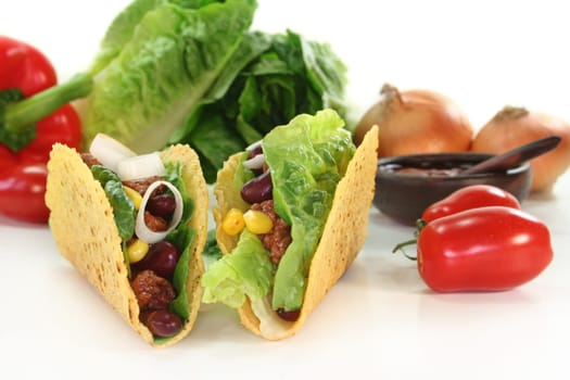 Taco shells stuffed with ground beef,kidney beans and corn