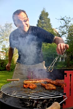 Man barbecuing behind clouds of intoxication