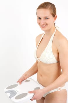 Young woman swaying on a bathroom scale