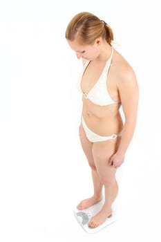 Young woman swaying on a bathroom scale
