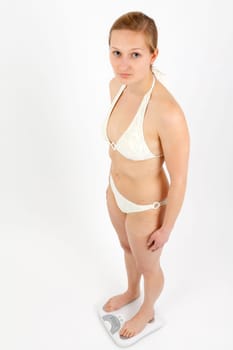 Young woman swaying on a bathroom scale