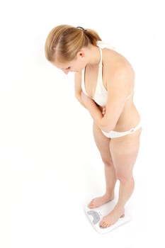 Young woman swaying on a bathroom scale