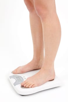 Young woman swaying on a bathroom scale