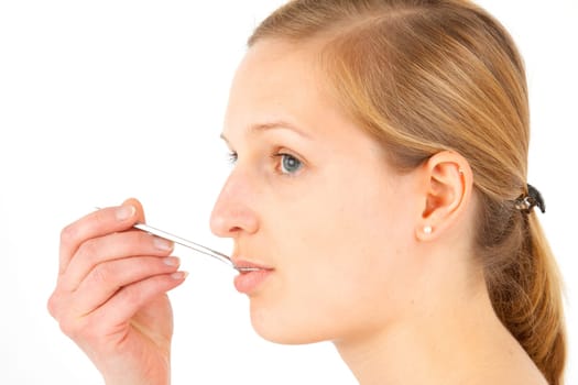 Woman taking medical drops