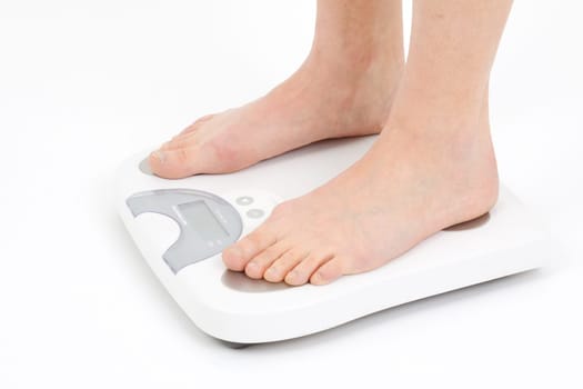 Young woman swaying on a bathroom scale