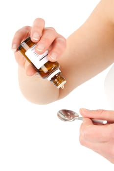 Young woman dripping medicine into a spoon