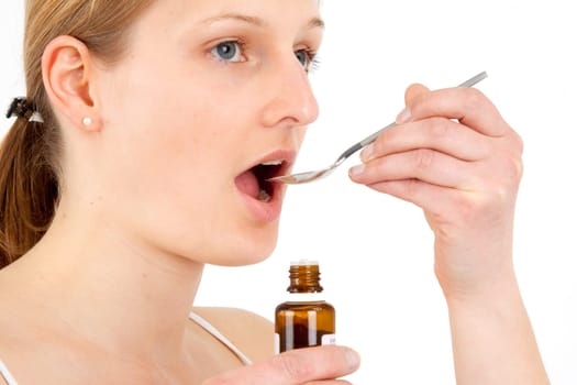 Woman taking medical drops