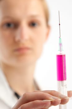 Young female doctor or nurse giving injection