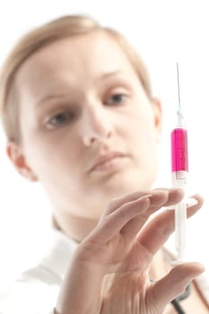 Young female doctor or nurse giving injection