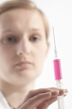 Young female doctor or nurse giving injection