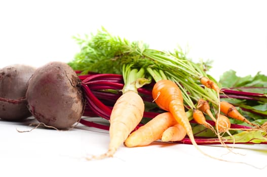 Shot of young beet and carrot isolated on white