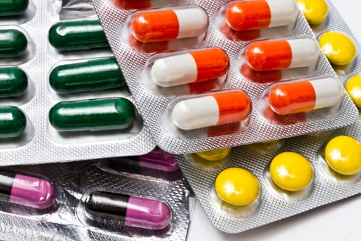 Colorful medicines closeup on white background