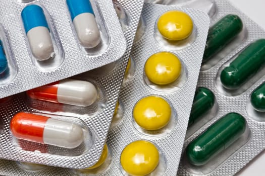 Background of capsules and pills closeup