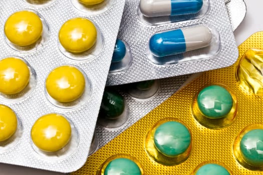 Background of capsules and pills closeup