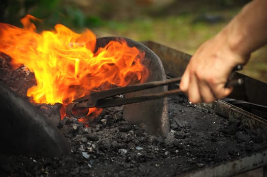 Blacksmith heating up iron - detail