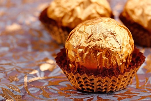 Closeup of chocolate wrapped in golden foil