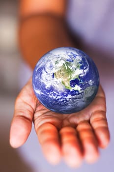 image composite of earth on palm, for conceptual usage.
