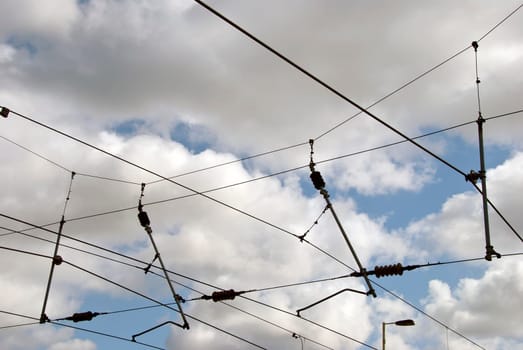 The overhead power cables of an electric railway line in Yorkshire England against a blue sky