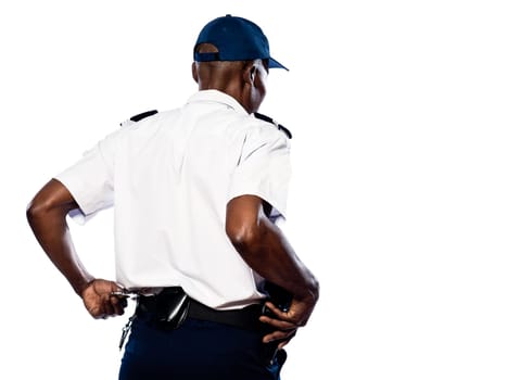 Rear view of afro American police officer pulling out handcuffs in studio on white isolated background