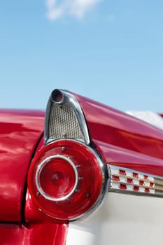 close up of 1960s red convertible car in Cuba. Vertical shape, copy space