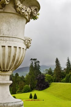 Mist and fog over the magnificient gardens at Powerscourt in Ireland. View over the beautifully sculptured flower vase at the top of the stairs.