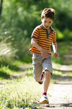 A young boy running in the nature
