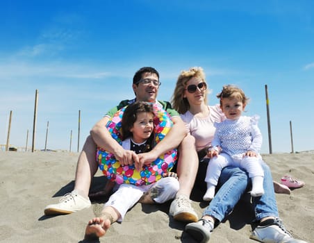 happy young family have fun and live healthy lifestyle on beach